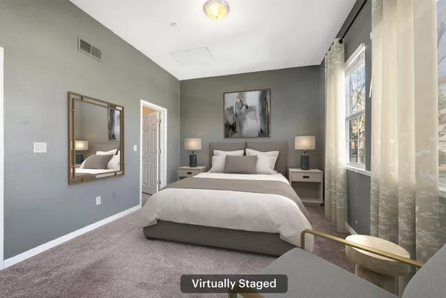 a bedroom with a bed and a painting on the wall