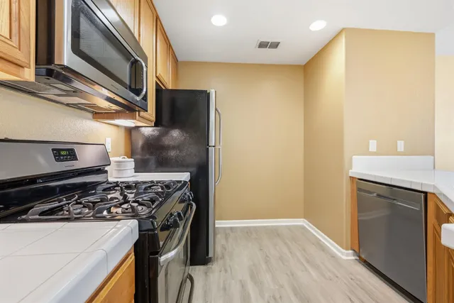 a kitchen with a stove and a refrigerator