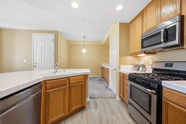 a kitchen with stainless steel appliances a stove microwave and cabinets