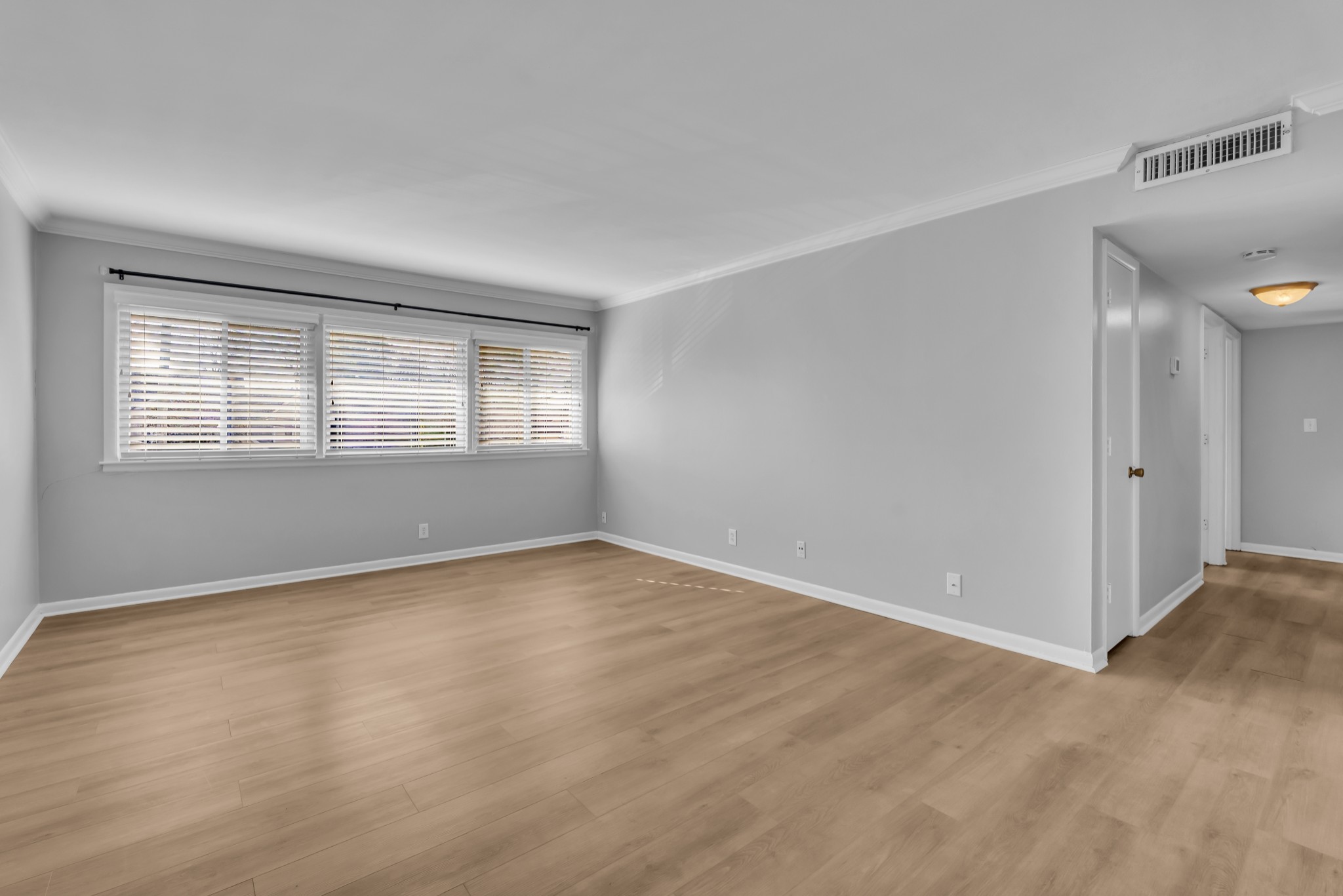 1900 Richard Jones Road, Unit R8 Nashville, TN 37215 - Photo 2 of 21 a view of an empty room with wooden floor and a window