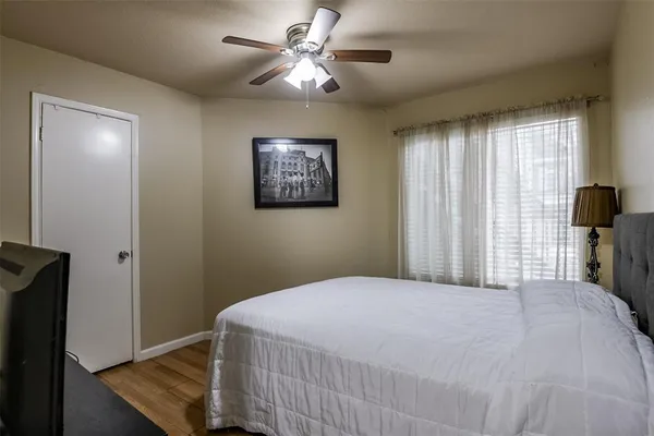 a bedroom with a bed and a painting on the wall