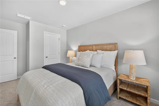 a bedroom with a bed and a lamp