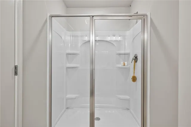 a bathroom with a glass shower door