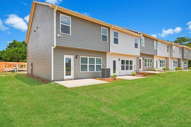 a front view of a house with a yard and porch
