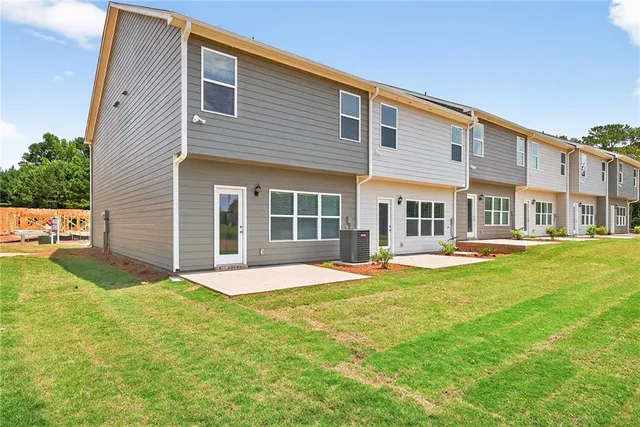 a front view of a house with a yard and porch