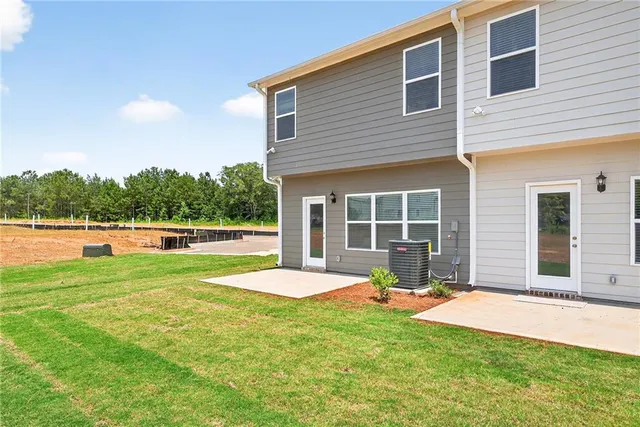 a view of a house with a yard and sitting area