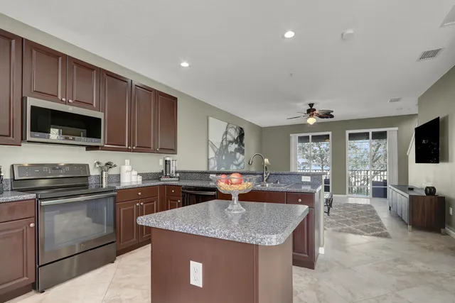 a kitchen with granite countertop a sink and cabinets