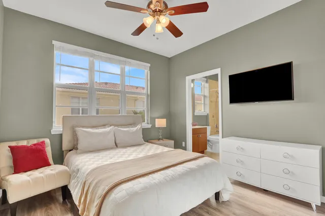 a bedroom with a bed and a flat screen tv