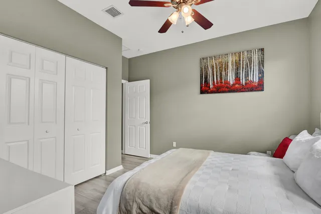 a bedroom with a bed and a chandelier