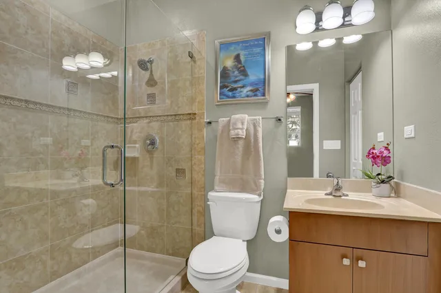 a bathroom with a toilet sink and shower