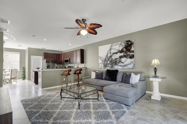a living room with furniture and kitchen view