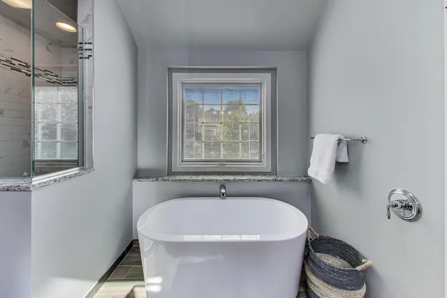 a white bath tub sitting in a bathroom