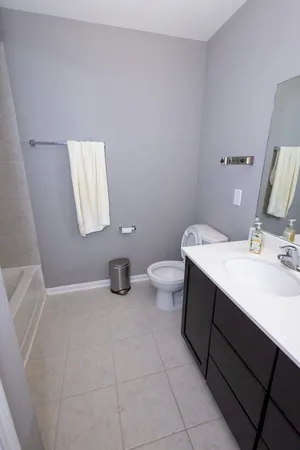a bathroom with a sink toilet and mirror