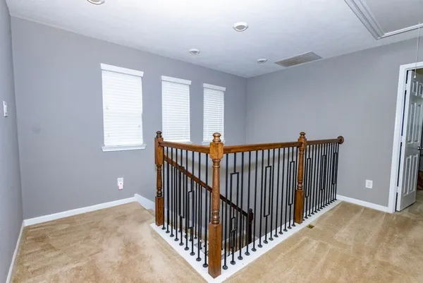 a view of a hallway with window and stairs