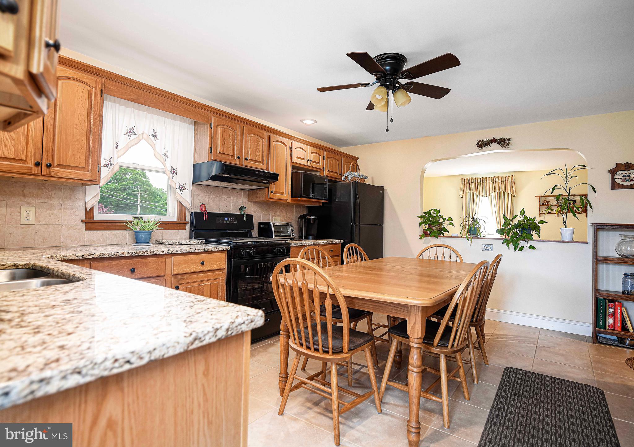 401 Riverside Road Baltimore, MD 21221 - Photo 23 of 41 a kitchen with stainless steel appliances kitchen island granite countertop a table chairs and a refrigerator