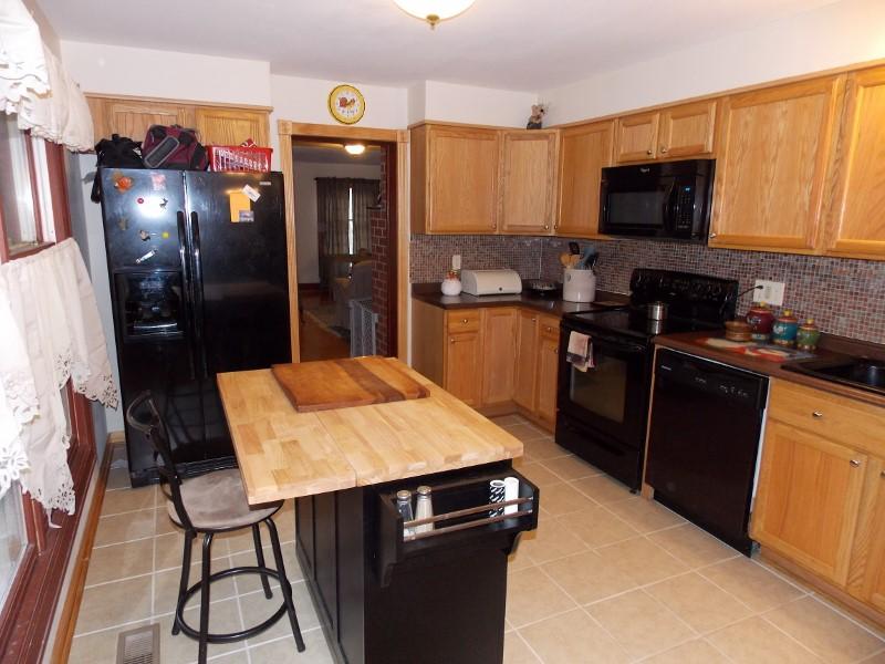 1612 Stonewall Road Northeast Check, VA 24072 - Photo 11 of 43 a kitchen with a sink refrigerator and microwave