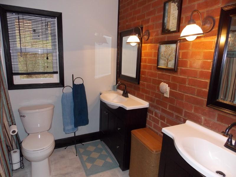 1612 Stonewall Road Northeast Check, VA 24072 - Photo 16 of 43 a bathroom with a toilet a sink and mirror