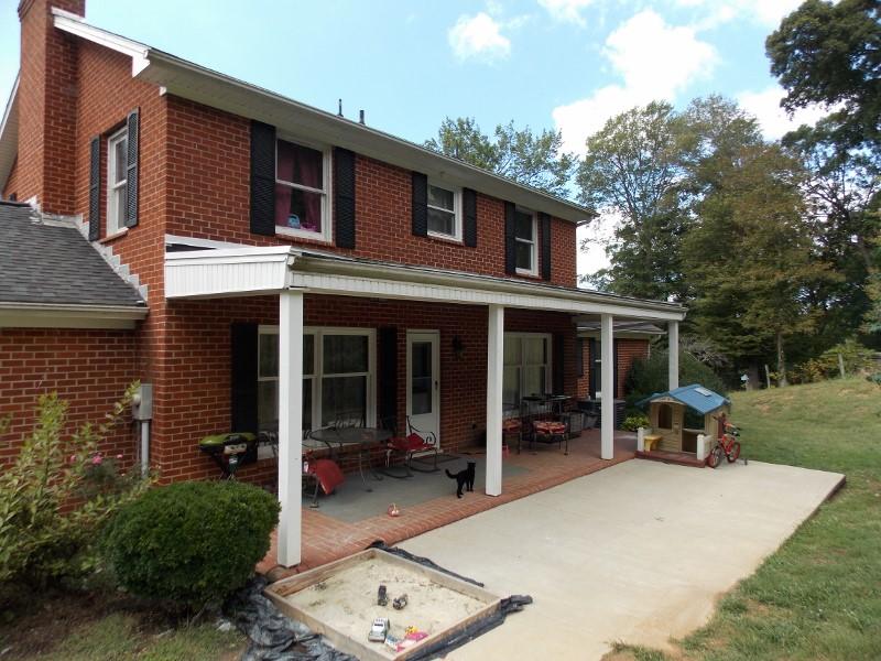 1612 Stonewall Road Northeast Check, VA 24072 - Photo 3 of 43 a view of a house with a yard and lawn chairs with a fire pit