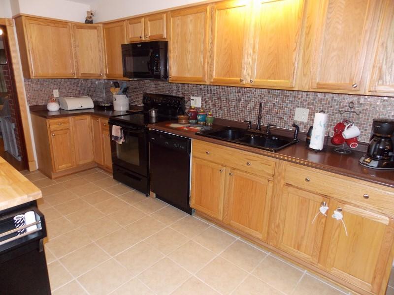 1612 Stonewall Road Northeast Check, VA 24072 - Photo 10 of 43 a kitchen with stainless steel appliances granite countertop a stove a sink and a microwave