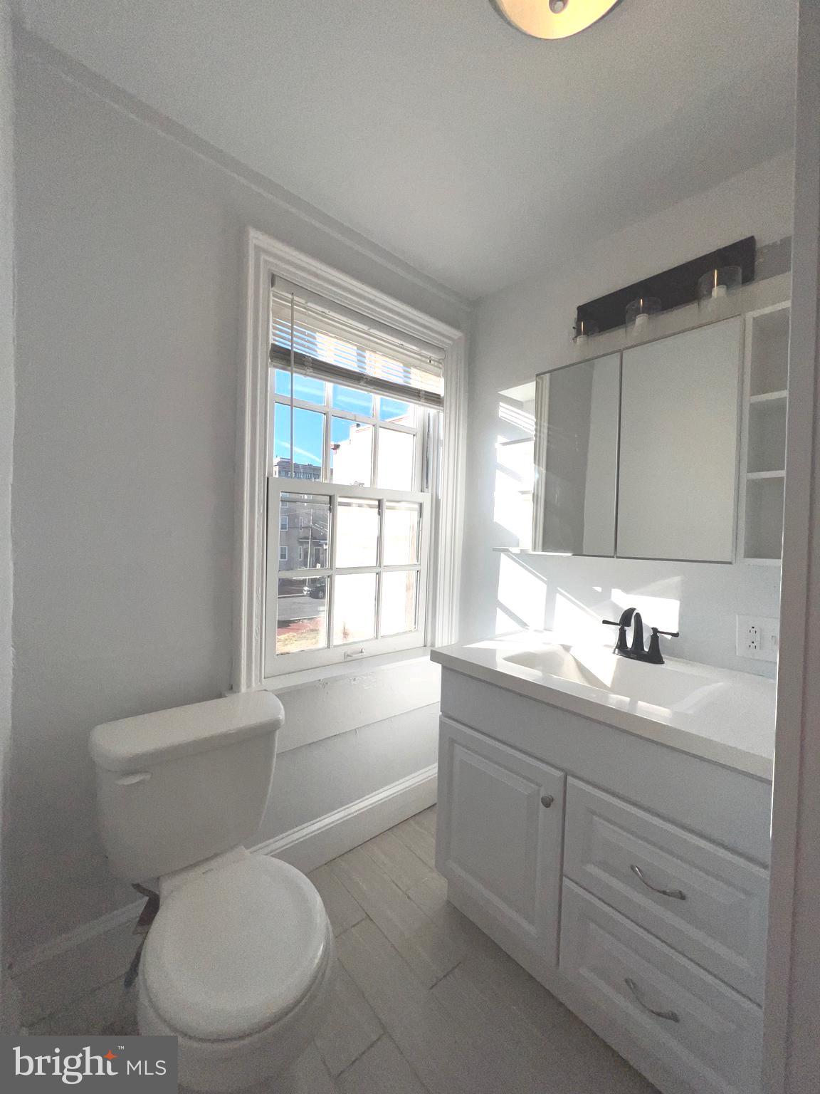 405 North 2nd Street Camden, NJ 08102 - Photo 11 of 15 a bathroom with a granite countertop toilet sink and mirror