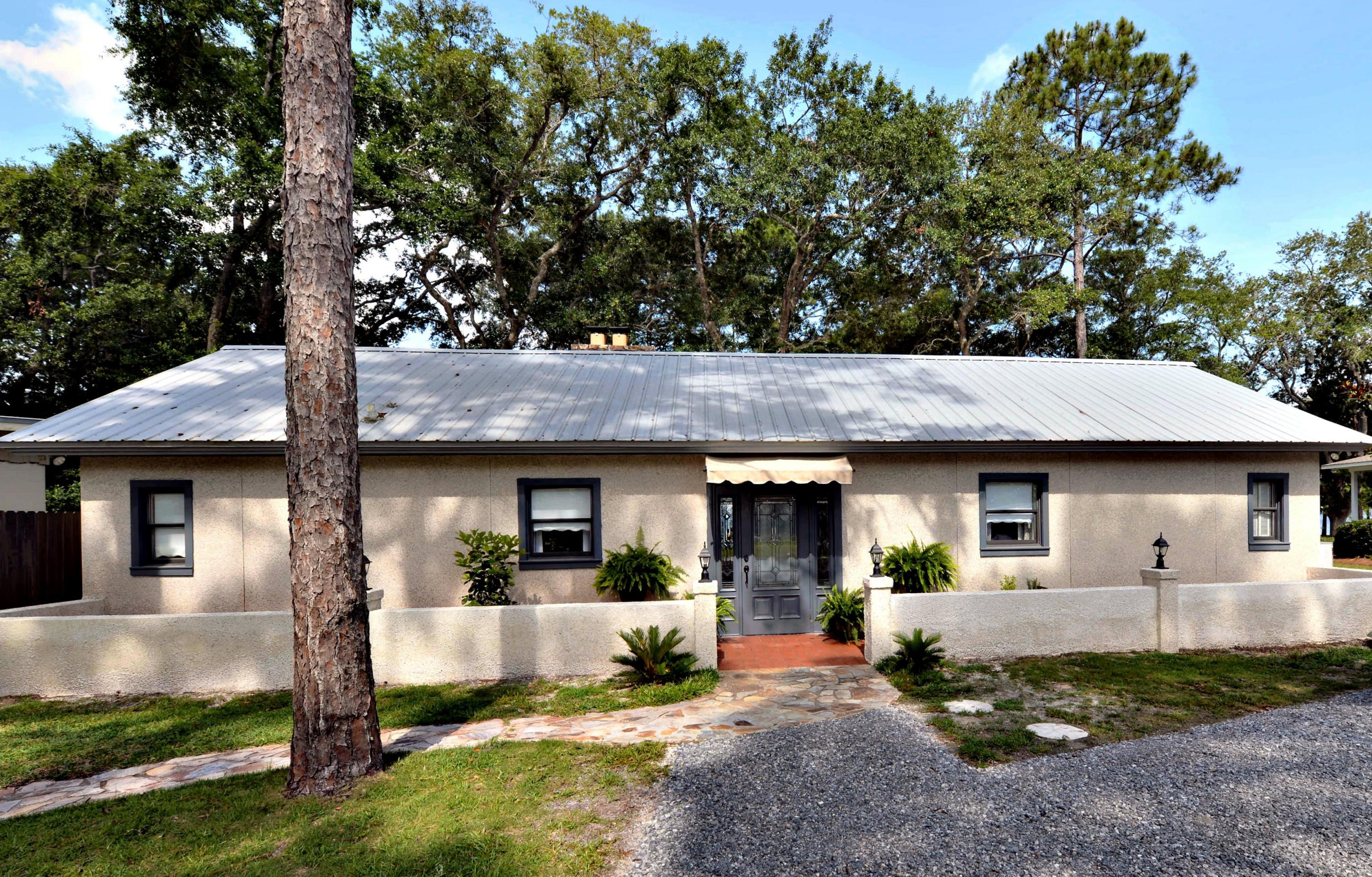 2394 Bay Grove Road Freeport, FL 32439 - Photo 1 of 37 a front view of a house with garden