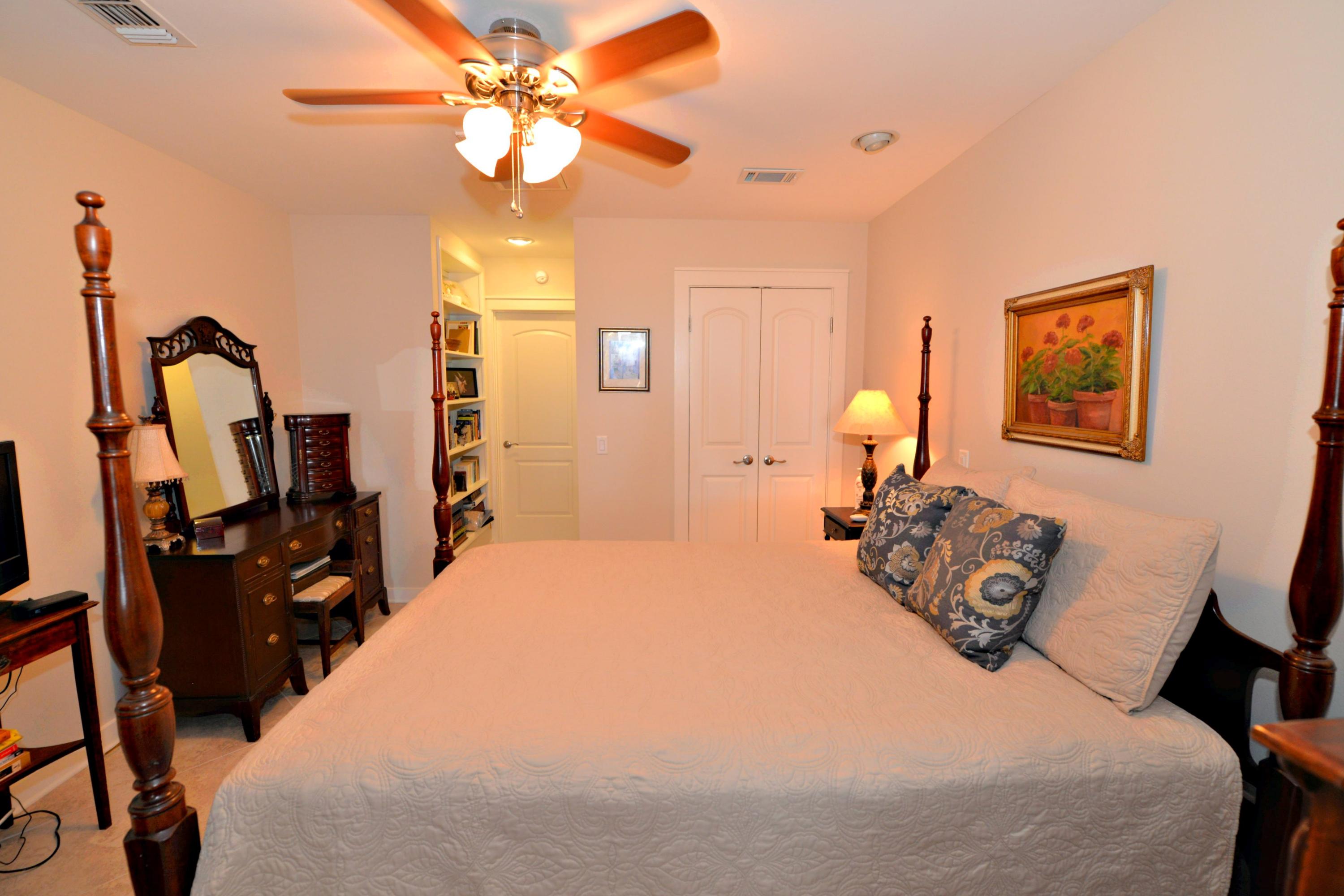 2394 Bay Grove Road Freeport, FL 32439 - Photo 17 of 37 a bedroom with a bed and a chandelier