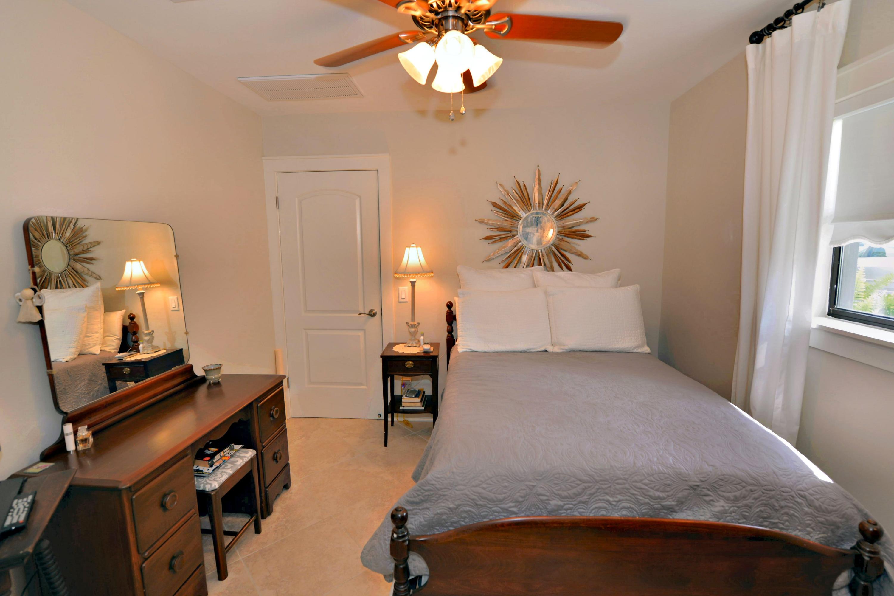 2394 Bay Grove Road Freeport, FL 32439 - Photo 21 of 37 a bedroom with a bed and a chandelier