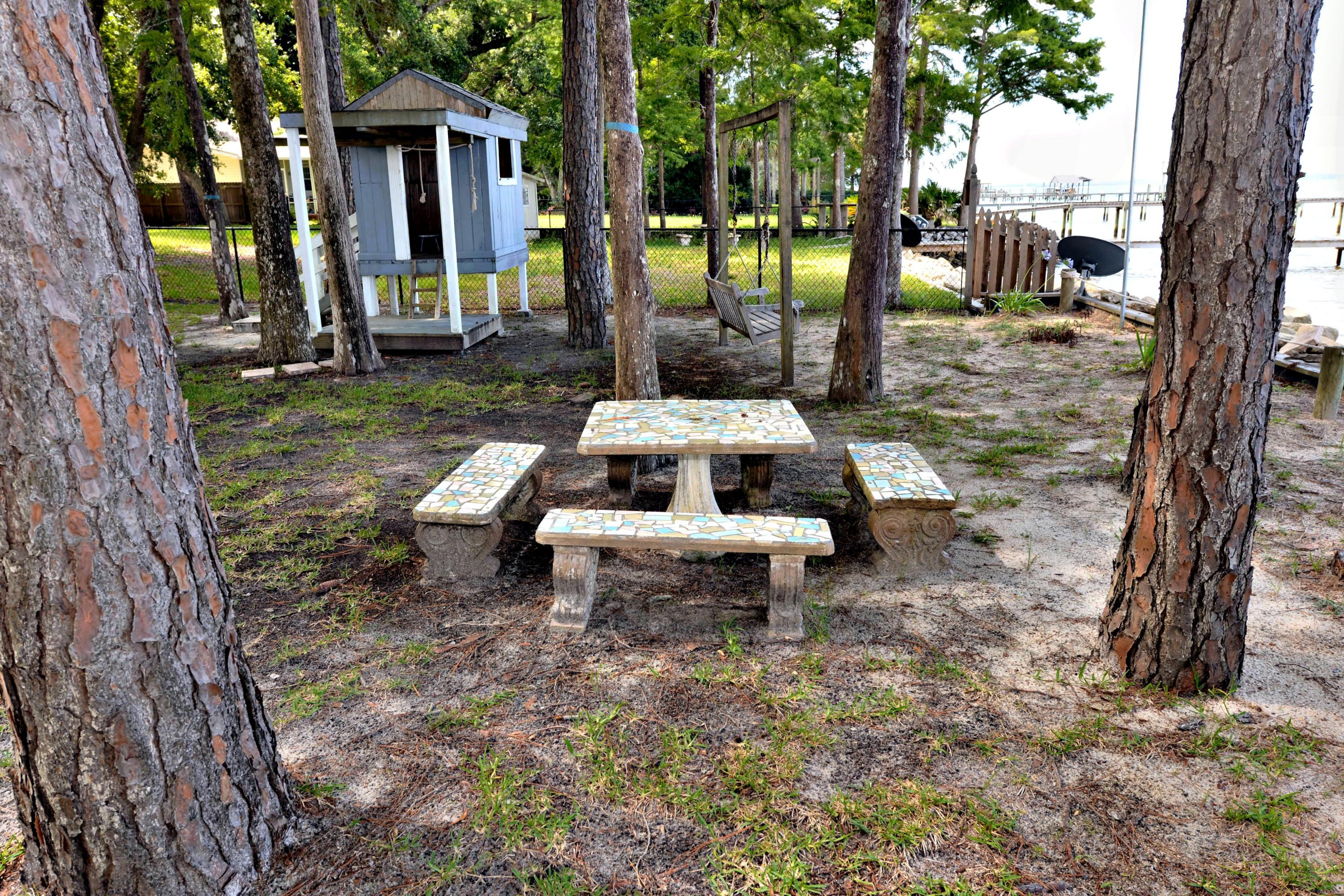 2394 Bay Grove Road Freeport, FL 32439 - Photo 29 of 37 a view of a yard with chairs and a table