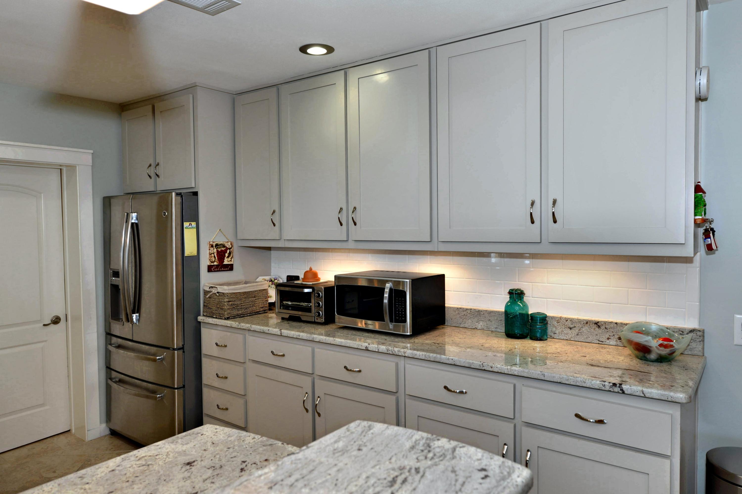 2394 Bay Grove Road Freeport, FL 32439 - Photo 4 of 37 a kitchen with stainless steel appliances white cabinets and refrigerator