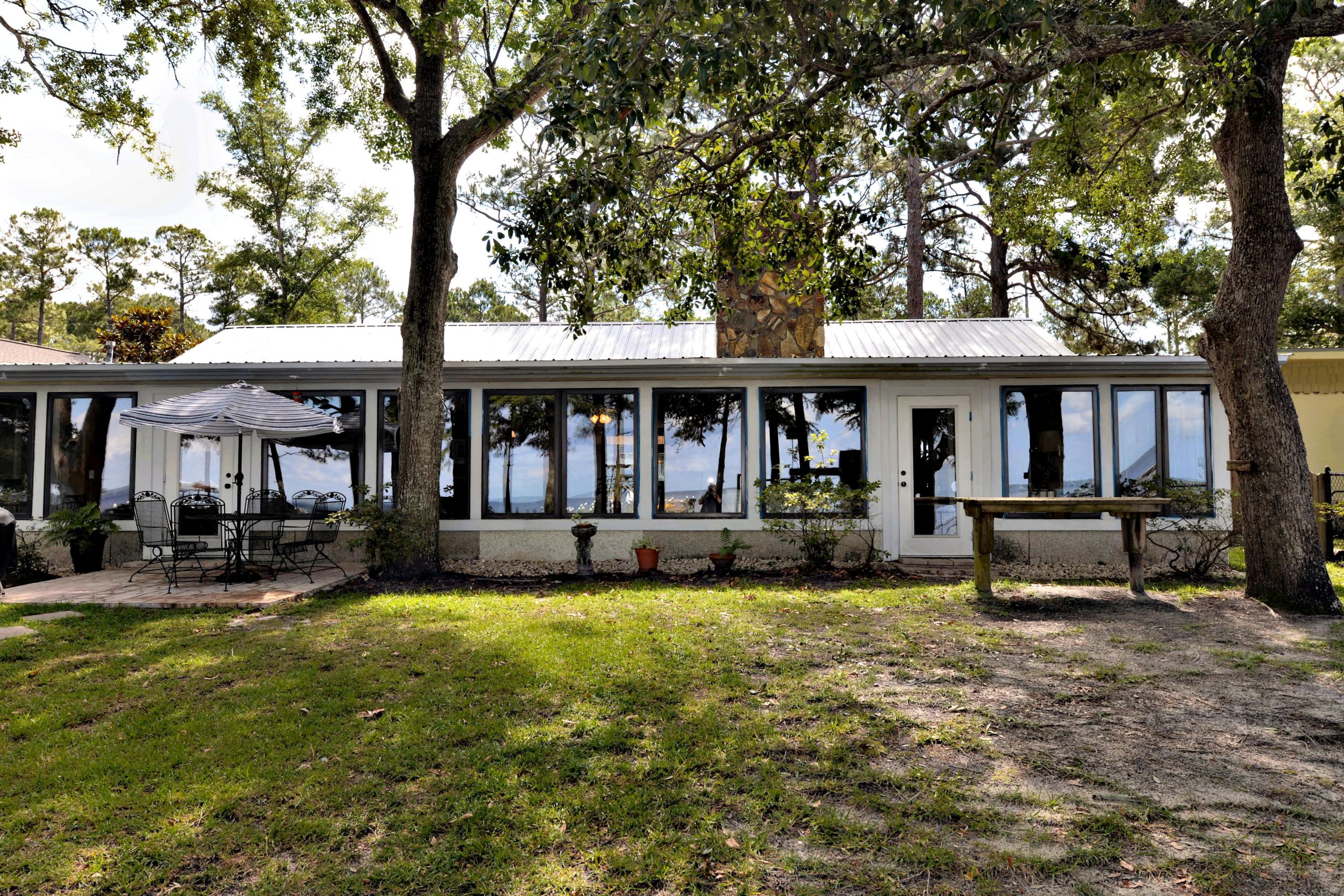 2394 Bay Grove Road Freeport, FL 32439 - Photo 33 of 37 a view of a house with swimming pool and sitting area