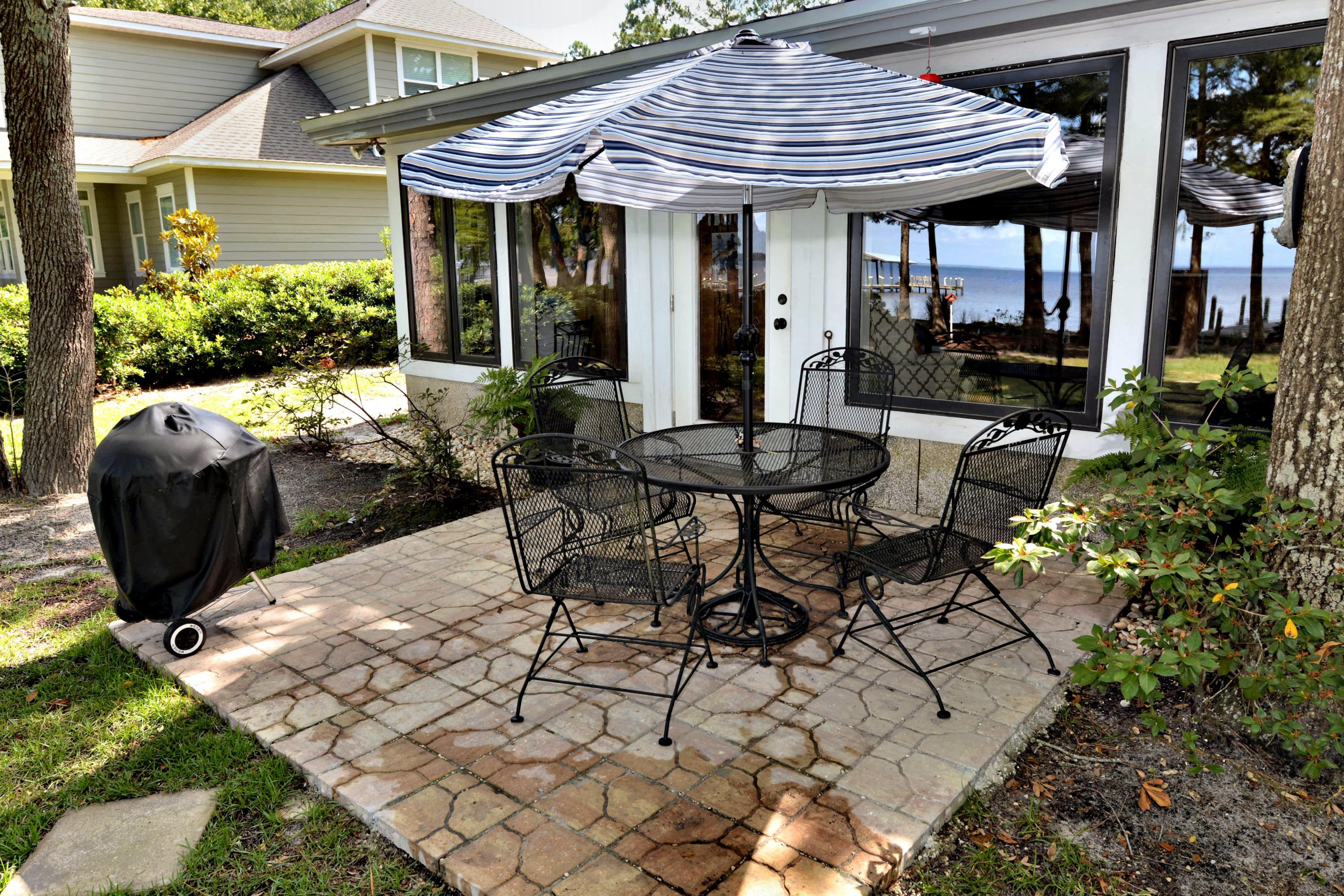 2394 Bay Grove Road Freeport, FL 32439 - Photo 35 of 37 a view of a chairs and table in backyard of the house