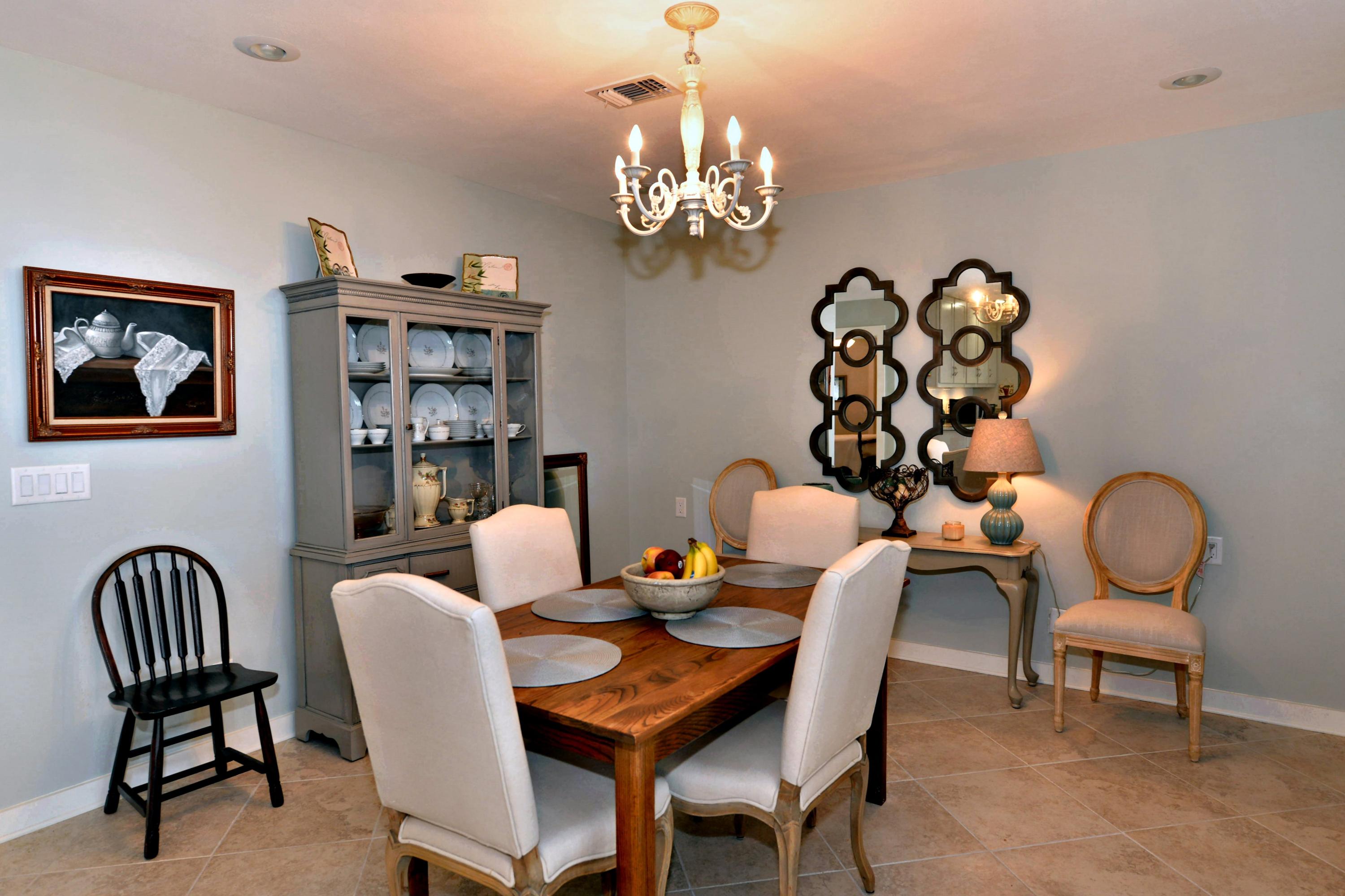 2394 Bay Grove Road Freeport, FL 32439 - Photo 7 of 37 a dining room with furniture a chandelier and window