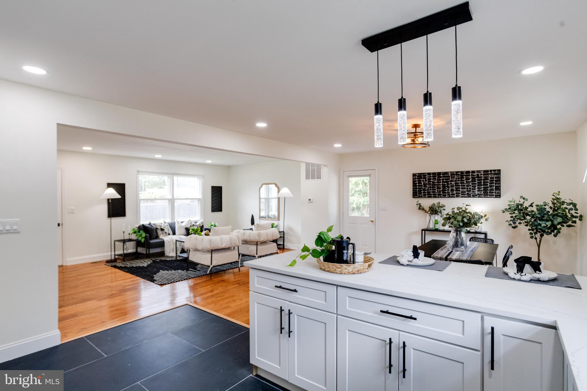 8041 Edgewater Avenue Rosedale, MD 21237 - Photo 12 of 38 a kitchen with white cabinets and couches
