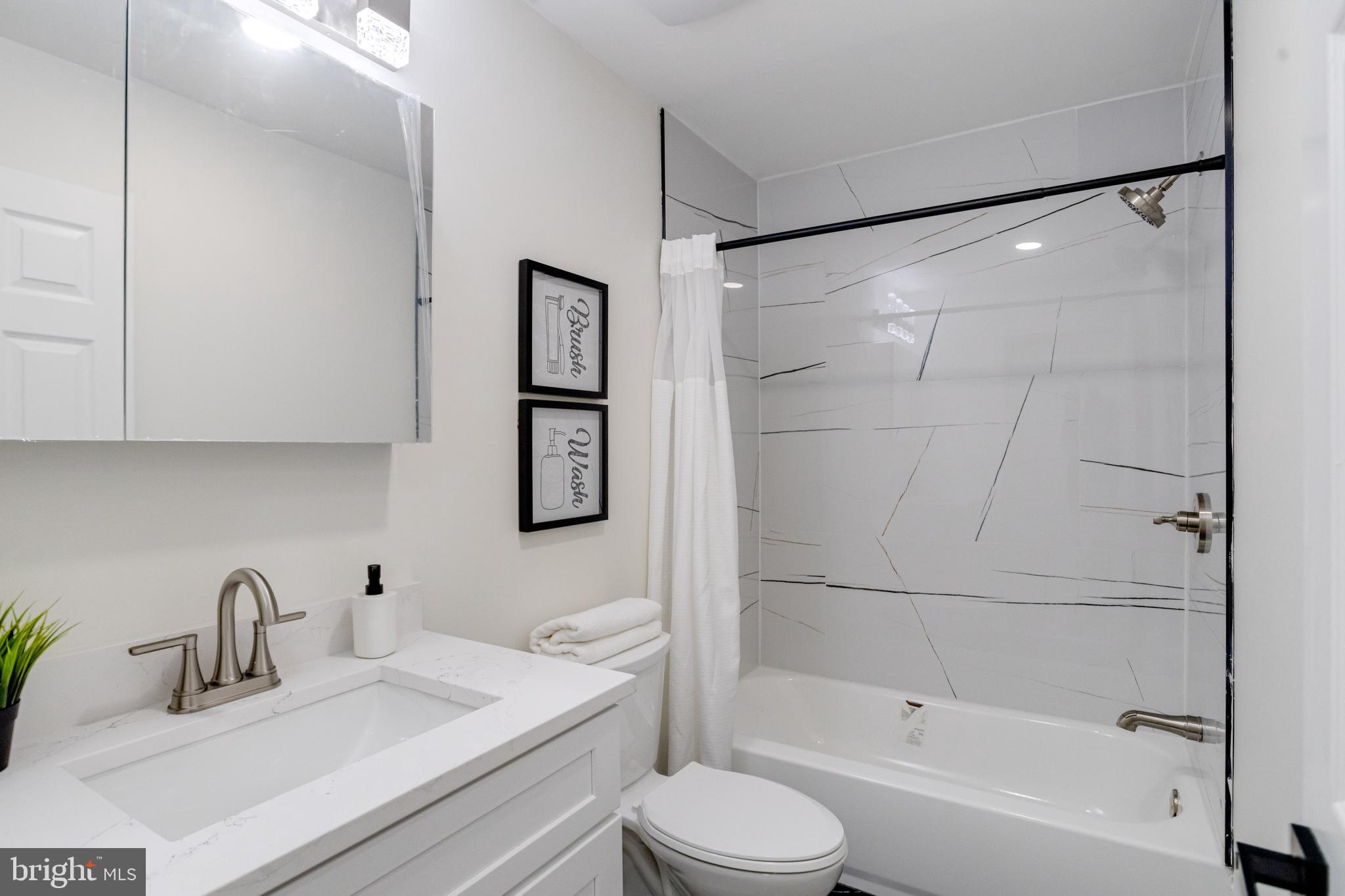 8041 Edgewater Avenue Rosedale, MD 21237 - Photo 21 of 38 a bathroom with a sink toilet and shower