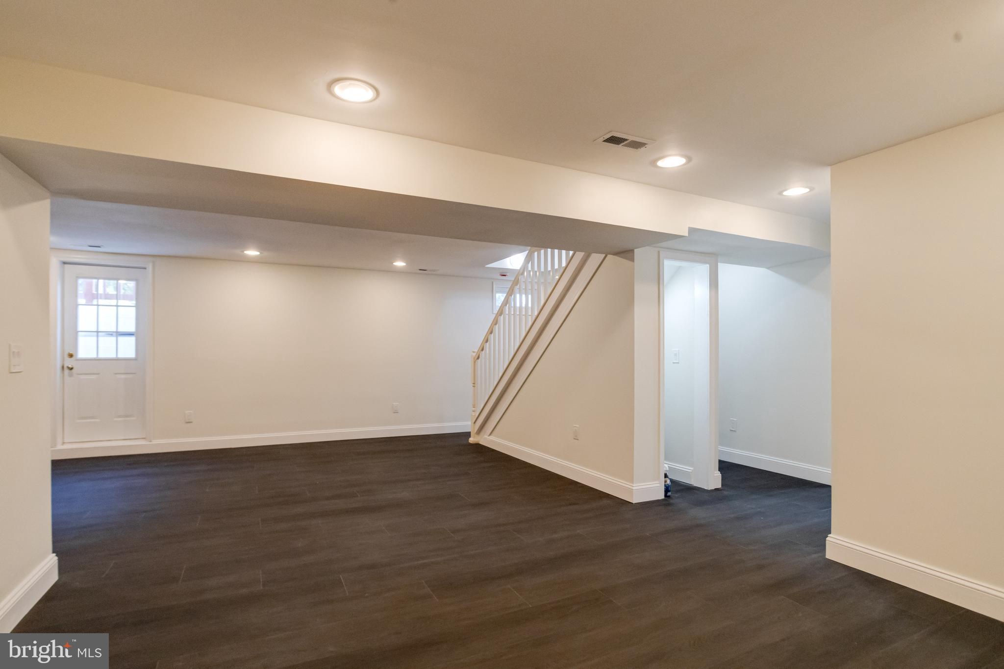 8041 Edgewater Avenue Rosedale, MD 21237 - Photo 27 of 38 a view of an empty room with wooden floor and a window
