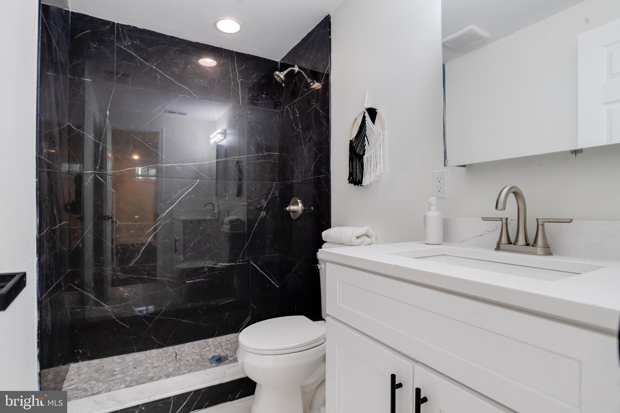 8041 Edgewater Avenue Rosedale, MD 21237 - Photo 29 of 38 a bathroom with a sink a toilet and shower