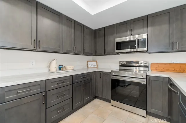a kitchen with cabinets stainless steel appliances and sink