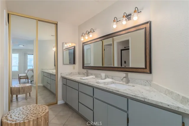 a bathroom with a double vanity sink and a mirror
