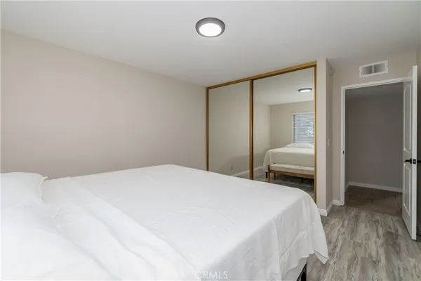 a bedroom with a bed and a mirror