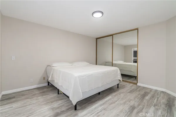 a bedroom with a bed and a night stand