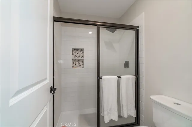 a bathroom with a shower and a toilet