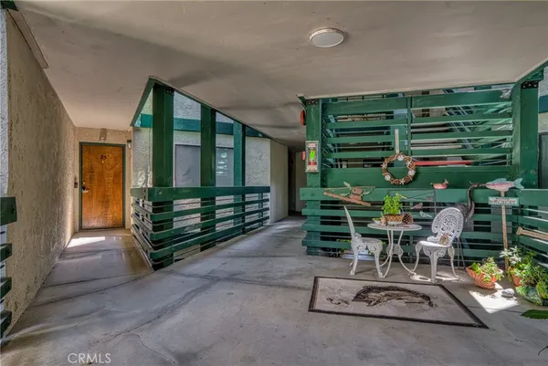 a room with lots of wooden furniture and a potted plant