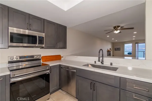 a kitchen with a sink stainless steel appliances and cabinets