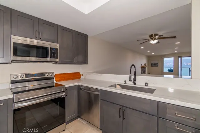 a kitchen with a sink stainless steel appliances and cabinets