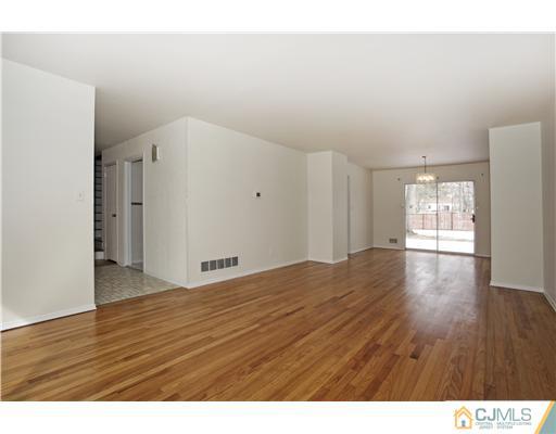 5 Roney Road Edison, NJ 08820 - Photo 12 of 25 a view of an empty room with wooden floor and a window