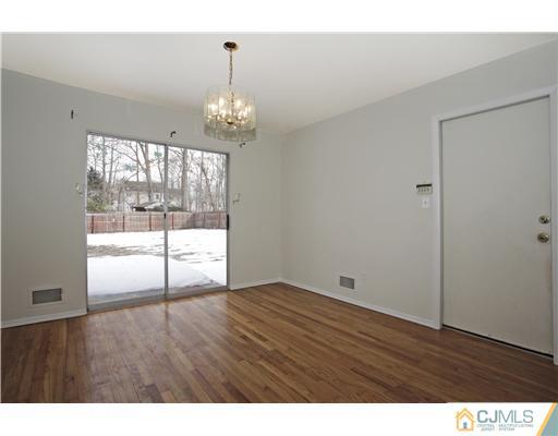 5 Roney Road Edison, NJ 08820 - Photo 14 of 25 a view of an empty room with wooden floor and a window