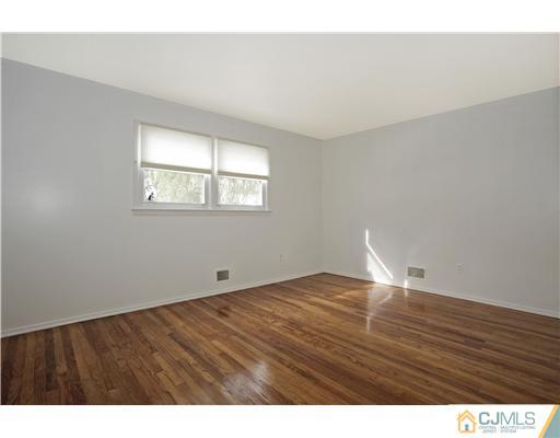 5 Roney Road Edison, NJ 08820 - Photo 19 of 25 a view of empty room with wooden floor