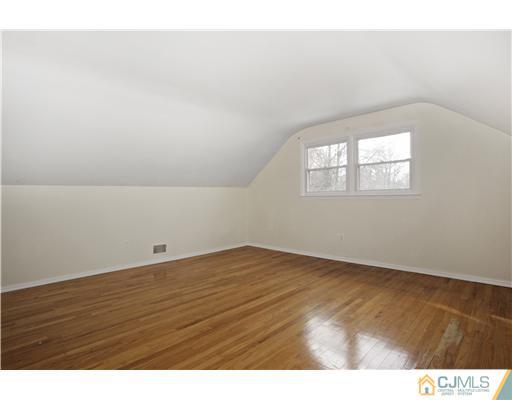 5 Roney Road Edison, NJ 08820 - Photo 21 of 25 an empty room with wooden floor and windows