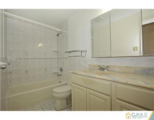 5 Roney Road Edison, NJ 08820 - Photo 24 of 25 a bathroom with a sink a toilet and shower