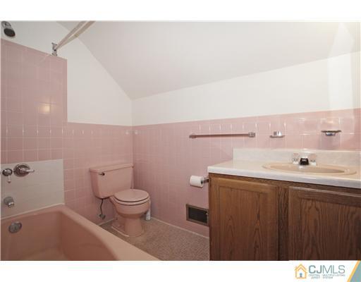 5 Roney Road Edison, NJ 08820 - Photo 25 of 25 a bathroom with a sink a toilet and a mirror